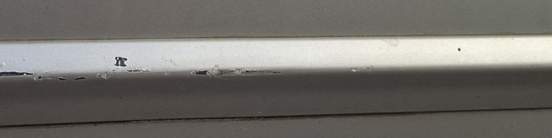 The original photo: a short scratch along the door trim