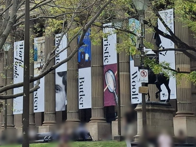 Exhibition banners hanging between the library's columns