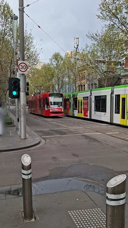 A still from the Android clip: two trams at a Melbourne stop